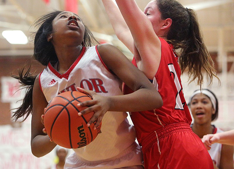 Baylor's Raegyn Conley (11) puts up a shot while being guarded by St. Cecilia's Sarah Davis (24) during the Baylor vs. St. Cecilia girls' basketball game Tuesday, Feb. 20, 2018 at Baylor School in Chattanooga, Tenn.