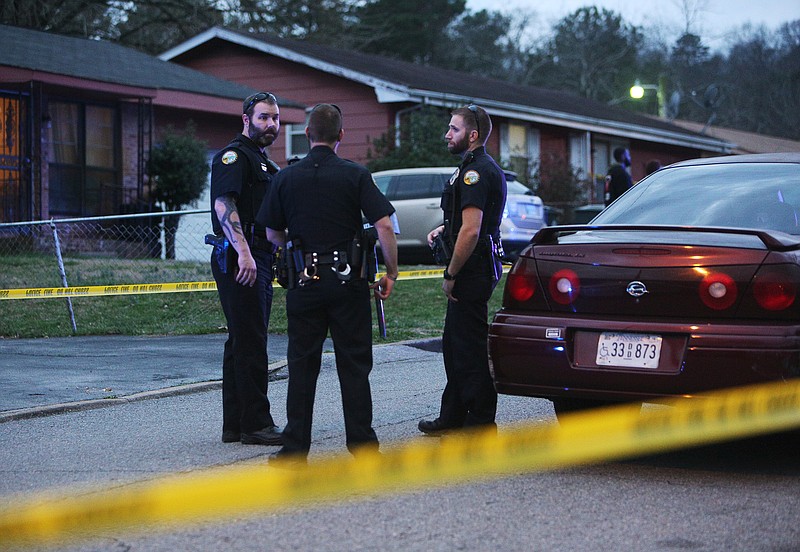 Chattanooga police officers work the scene of a shooting Tuesday, Feb. 20, 2018 in the 1400 block of Carousel Road in Chattanooga, Tenn. One person is deceased following the incident and another is in critical condition. 