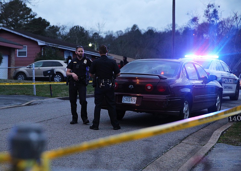 Chattanooga police officers work the scene of a shooting Tuesday, Feb. 20, 2018 in the 1400 block of Carousel Road in Chattanooga, Tenn. One person is deceased following the incident and another is in critical condition. 