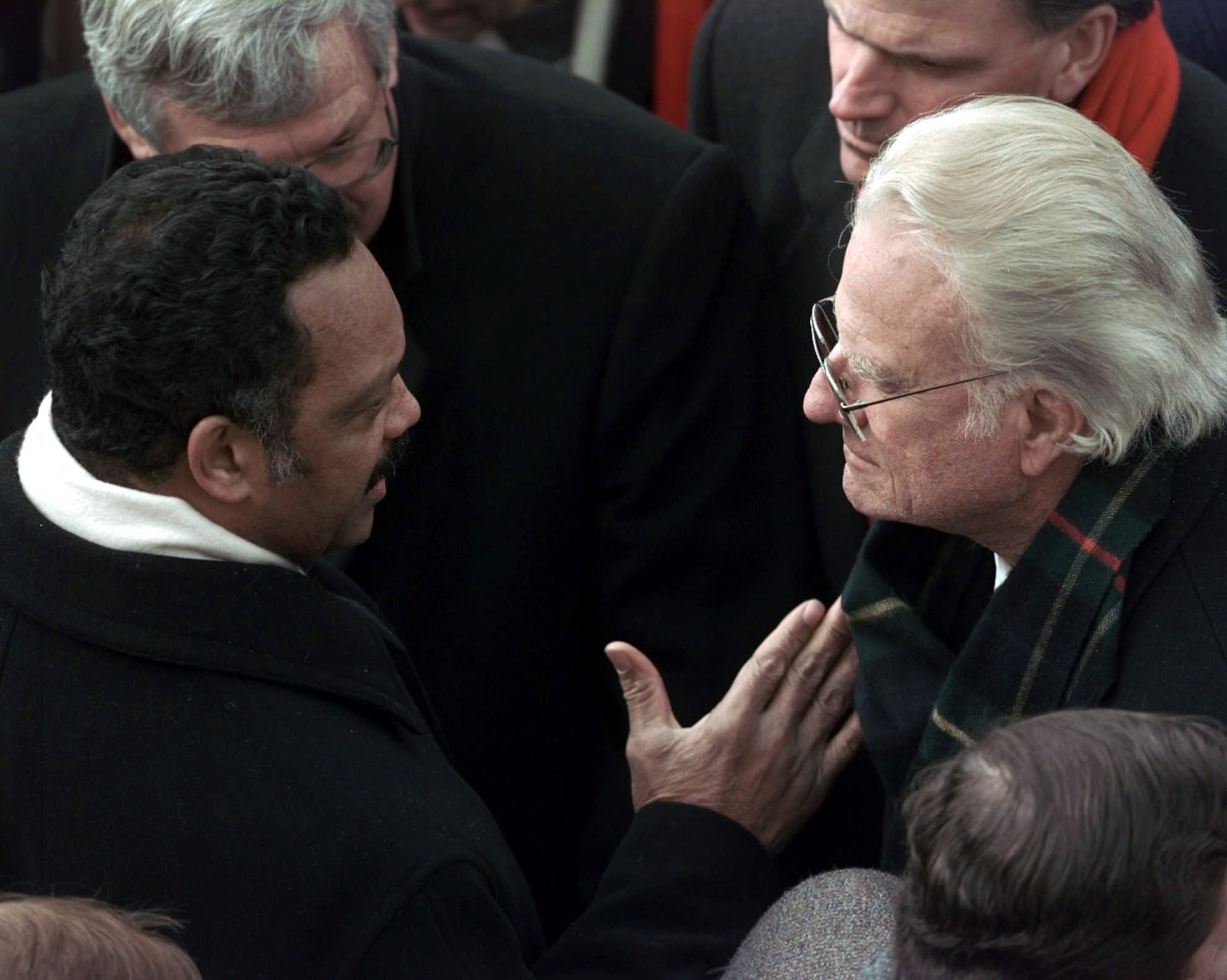 The Reverend Jesse Jackson, left, speaks with The Reverend Billy Graham during the 53rd Presidential Inauguration Monday, Jan. 20, 1997, in Washington. (AP Photo/Wilfredo Lee)
