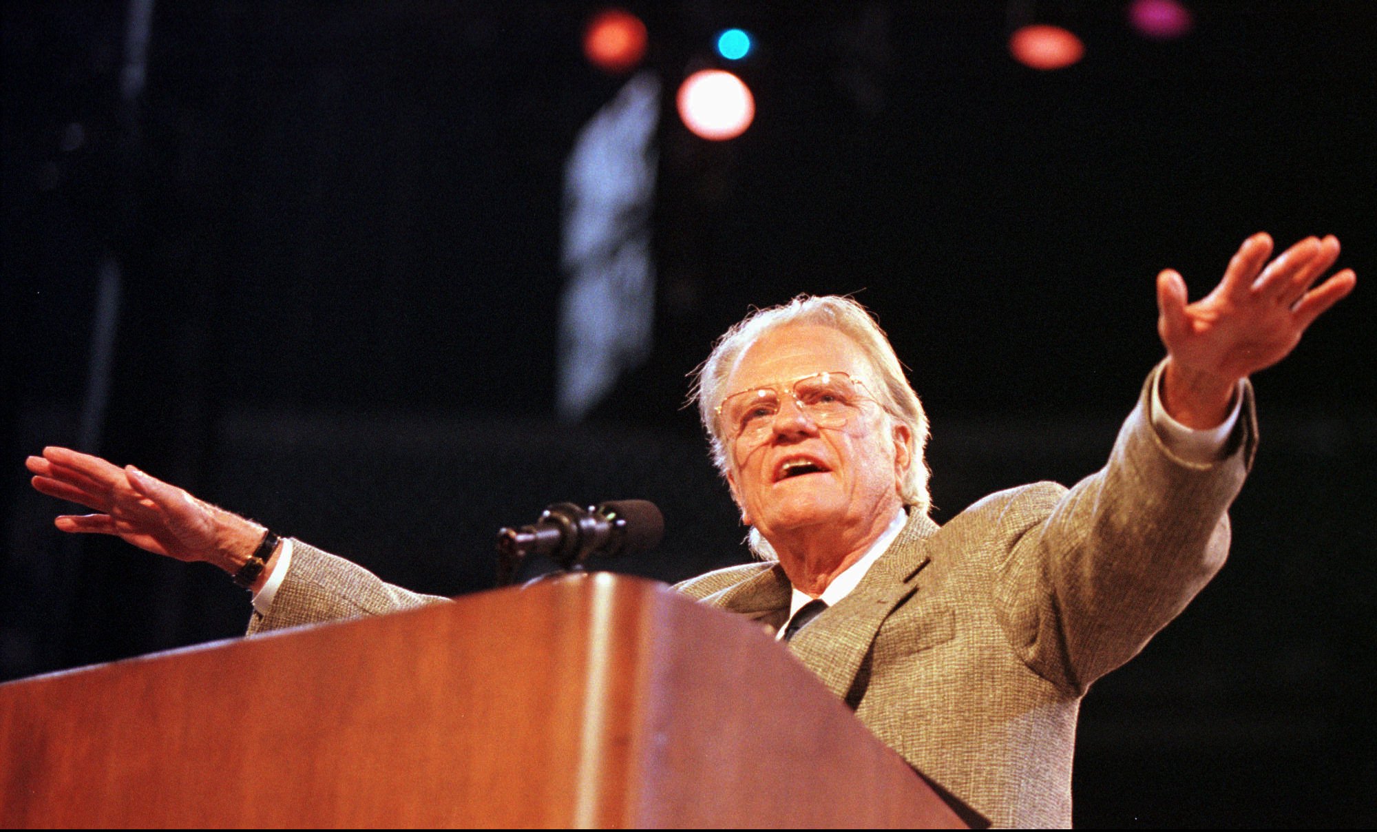 Rev. Billy Graham gestures while speaking to teens Saturday, Oct. 25, 1997, during "A Concert for the Next Generation" in Oakland, Calif. An evangelist for more than 50 years, Graham is reaching out to the young. (AP Photo/Terry Schmitt)