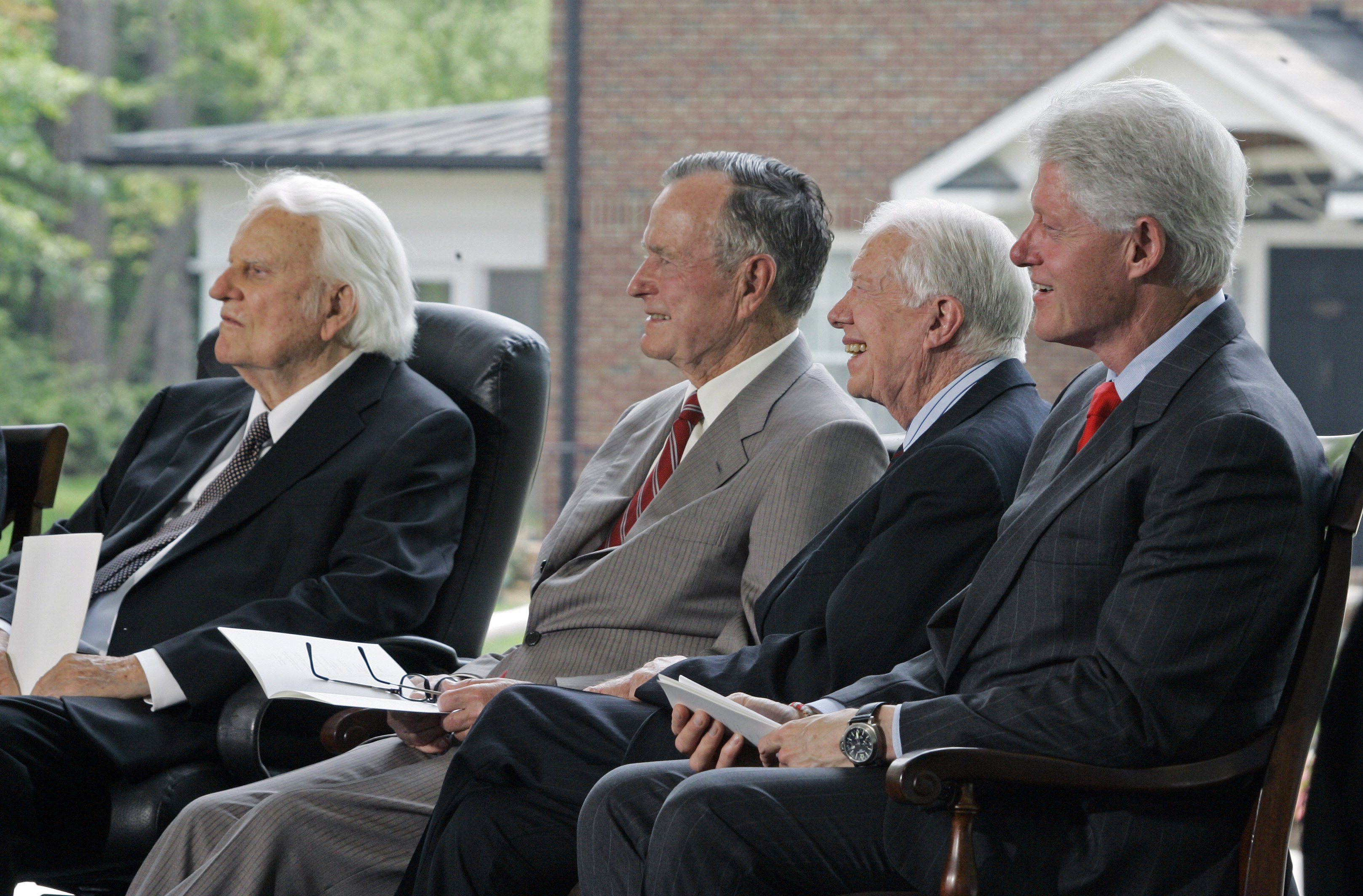 Former presidents, from right, Bill Clinton, Jimmy Carter and George H.W. Bush, look on with Rev. Billy Graham, left, during a dedication for the Billy Graham Library in Charlotte, N.C., Thursday, May 31, 2007. (AP Photo/Chuck Burton)