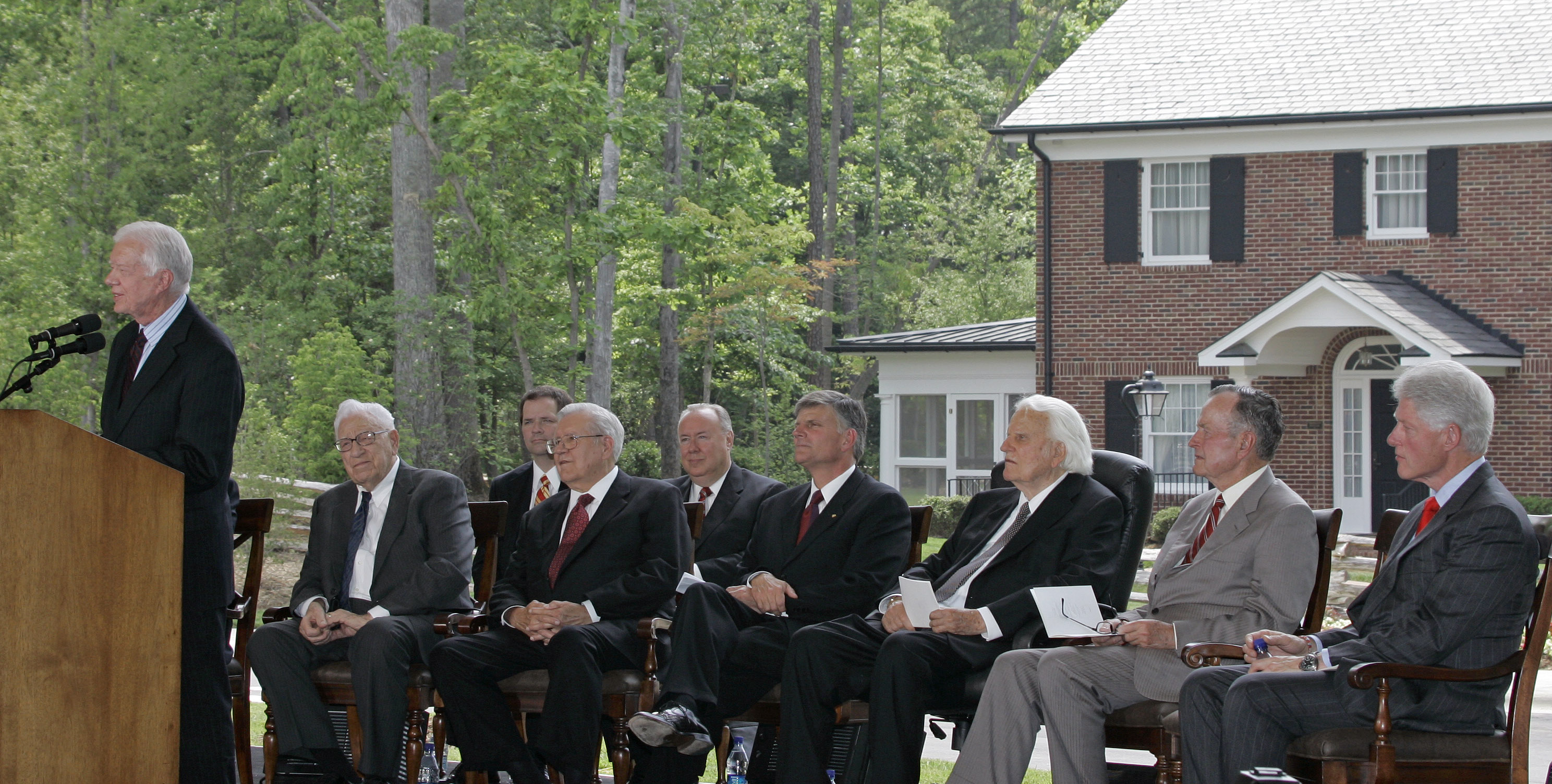 Former President Jimmy Carter, left, speaks as, from left, George Beverly Shea, Cliff Barrows, Franklin Graham, Billy Graham, George H.W. Bush, and Bill Clinton look on during a dedication for the Billy Graham Library in Charlotte, N.C., Thursday, May 31, 2007. (AP Photo/Chuck Burton)