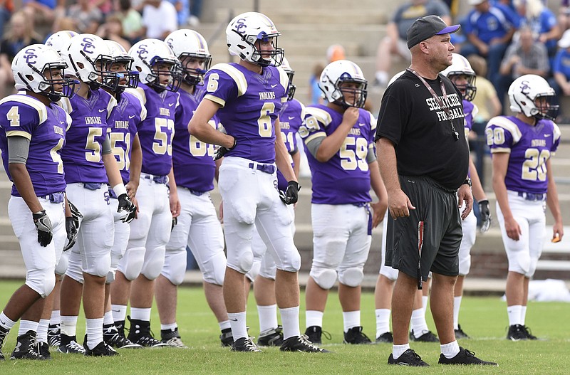 Adam Caine, shown with the Sequatchie County High School football team before a jamboree matchup last year, has resigned as the Indians' coach to become the coach at Upperman.