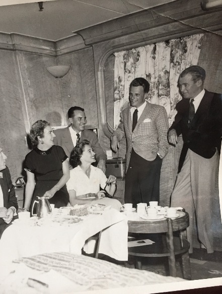 The Rev. Billy Graham, center, with Jimmy Stewart, right, aboard the Queen Mary during a European crusade. Chattanooga reporter George Branahm accompanied Graham on the tour and filed daily columns.