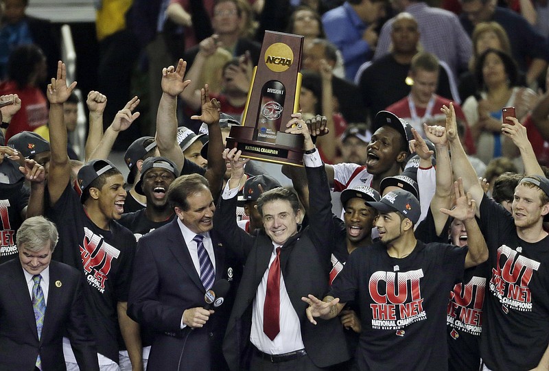 In this April 8, 2013, file photo, Louisville players and head coach Rick Pitino celebrate after defeating Michigan 82-76 in the championship of the Final Four in the NCAA college basketball tournament in Atlanta. Louisville must vacate its 2013 men's basketball title following an NCAA appeals panel's decision to uphold sanctions against the men's program for violations committed in a sex scandal. The Cardinals will have to vacate 123 victories including the championship, and return millions in postseason revenue. The decision announced on Tuesday, Feb. 20, 2018, by the governing body's Infraction Appeals Committee ruled that the NCAA has the authority to take away championships for what it considers major rule violations. (AP Photo/Chris O'Meara, File)