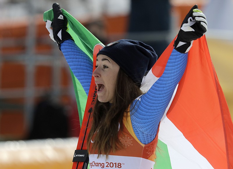 Gold medal winner Sofia Goggia, of Italy, reacts during the flower ceremony for the women's downhill at the 2018 Winter Olympics in Jeongseon, South Korea, Wednesday, Feb. 21, 2018. (AP Photo/Michael Probst)