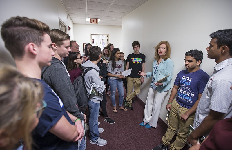 Florida Rep. Kristin Jacobs talks with student survivors from Marjory Stoneman Douglas High School in the hallway at the Florida Capitol in Tallahassee, Fla., Feb 21, 2018. The students from Marjory Stoneman Douglas High School are in town to lobby the Florida Legislature after a shooting that left 17 dead at their school. (AP Photo/Mark Wallheiser)

