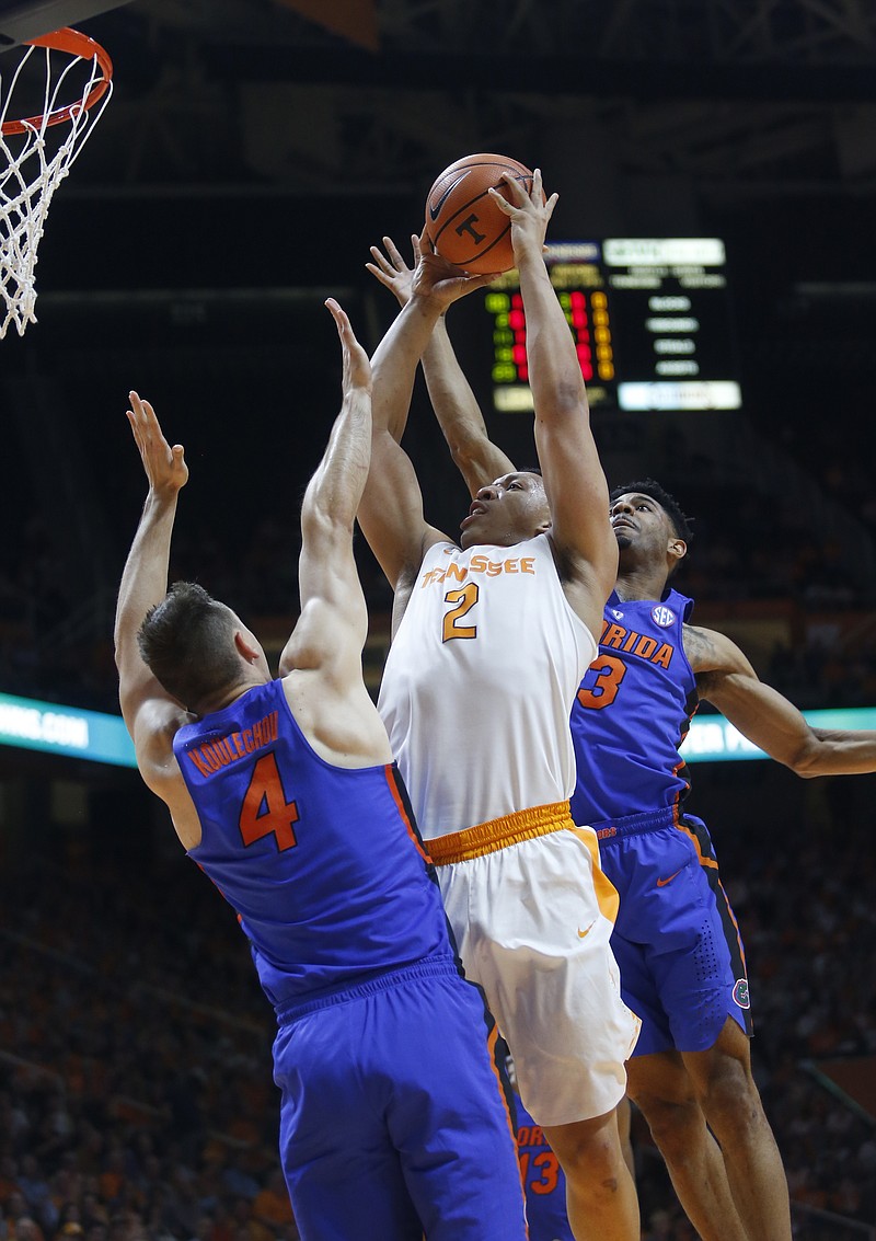 Tennessee forward Grant Williams (2) is defended by Florida guard Egor Koulechov and guard Jalen Hudson (3) in the first half of an NCAA college basketball game Wednesday, Feb. 21, 2018, in Knoxville, Tenn. (AP Photo/Crystal LoGiudice)