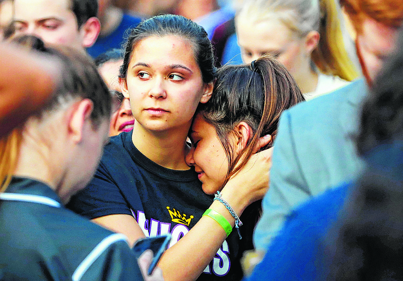 Julia Salomone, 18, left, and her sister Lindsey Salomone, 15, student survivors from Marjory Stoneman Douglas High School hug as they march to the state capitol in Tallahassee, Fla., to challenge lawmakers on gun control reform. (AP Photo/Gerald Herbert)