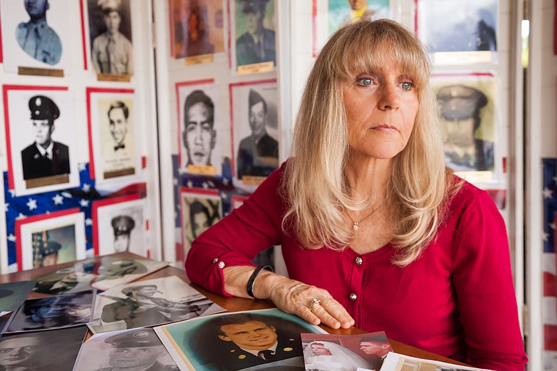 Janna Hoehn at home in Kihei on Maui on 5.22.15. Hoehn is going through images of fallen Vietnam War soldiers sent to her by families all over the country. Hoehn photographed in her