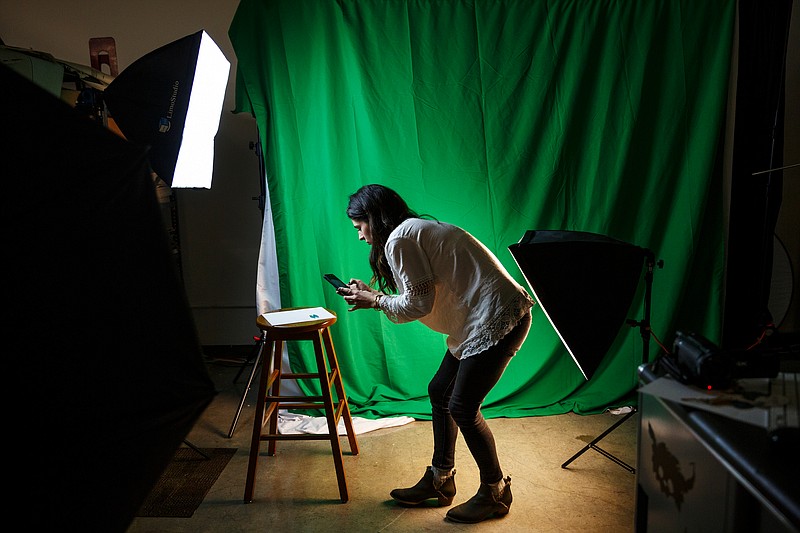 Alex Nelson, who makes jewelry, uses a 3rd floor studio at the Chattanooga Public Library to photograph her work and help promote her business on Friday, Feb. 16, 2018, in Chattanooga, Tenn. City council members recently toured the library and foresee opportunities to use the facility's technology services for vocational training.