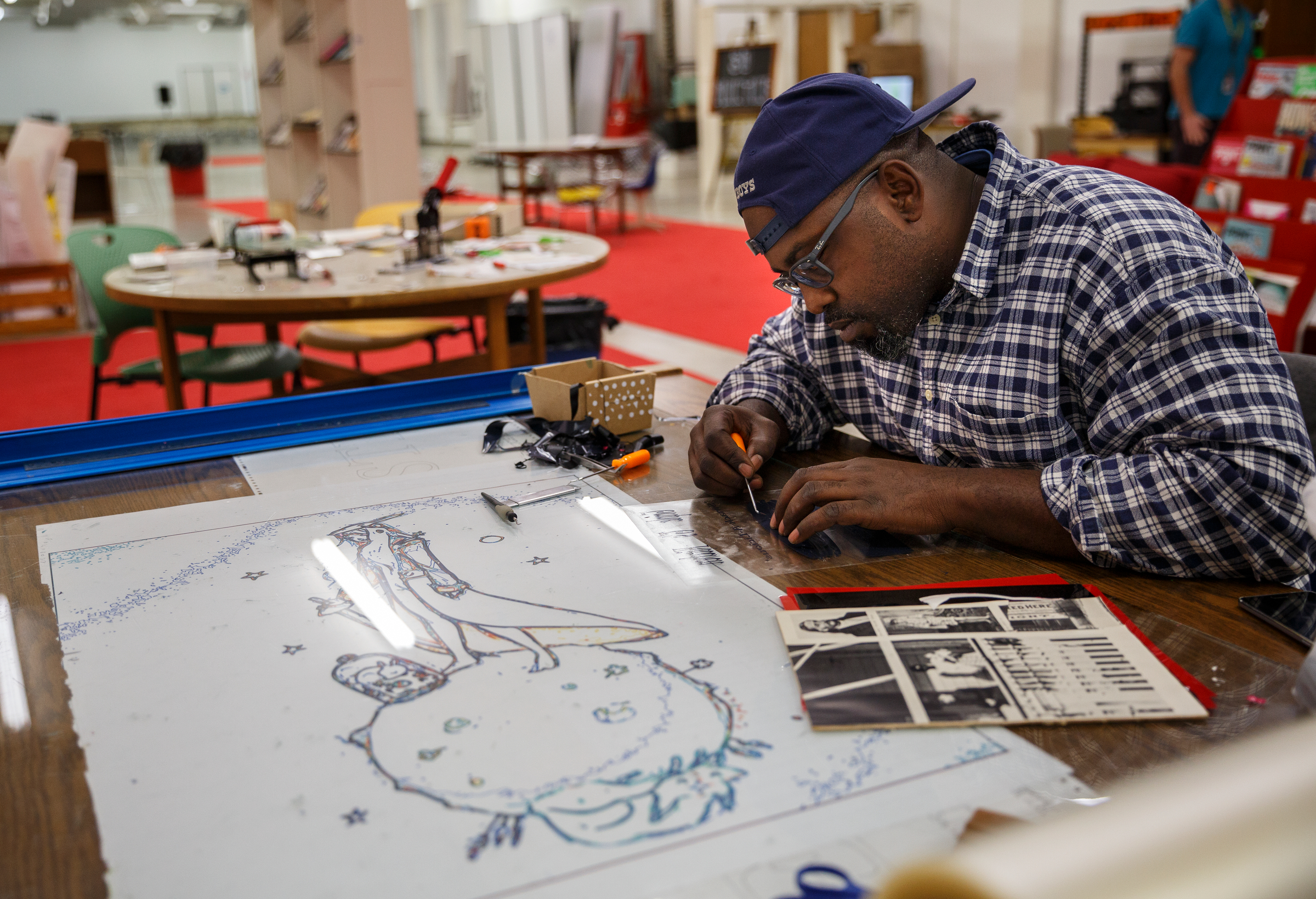 Malcolm Robinson uses resources on the 3rd floor of the Chattanooga Public Library while designing a t-shirt for a client on Friday, Feb. 16, 2018, in Chattanooga, Tenn. City council members recently toured the library and foresee opportunities to use the facility's technology services for vocational training.
