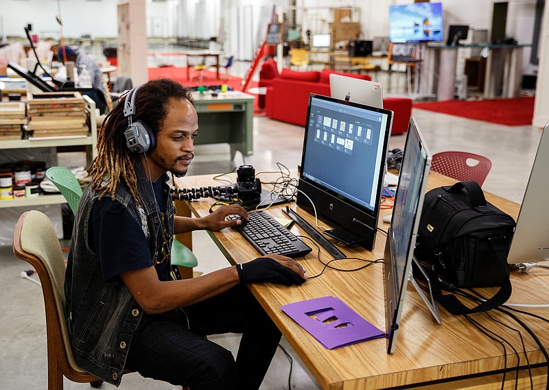 Gurukrisna uses a computer on the 3rd floor of the Chattanooga Public Library to edit photos and video for his business on Friday, Feb. 16, 2018, in Chattanooga, Tenn. City council members recently toured the library and foresee opportunities to use the facility's technology services for vocational training.