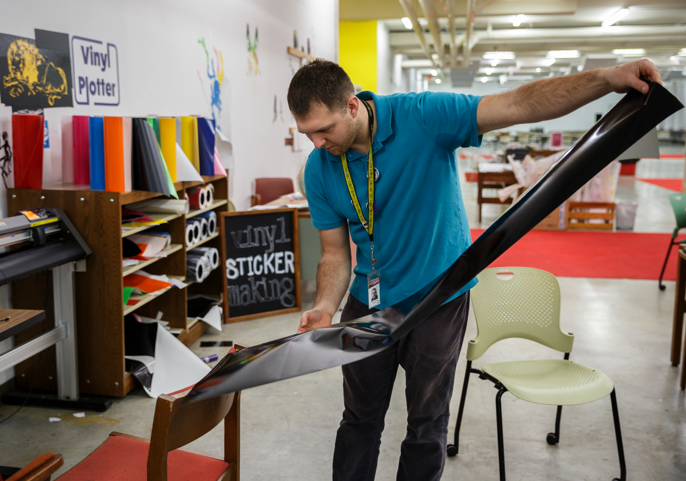 Librarian Thomas Anderson unrolls a vinyl sticker made by 6th grade teacher Rebecca Lefkoff using a vinyl plotter on the 3rd floor of the Chattanooga Public Library on Friday, Feb. 16, 2018, in Chattanooga, Tenn. City council members recently toured the library and foresee opportunities to use the facility's technology services for vocational training.