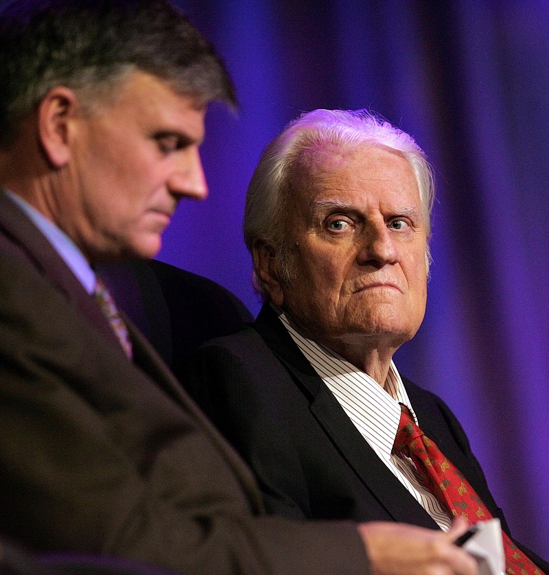 
              FILE - In this March 12, 2006 file photo, the Rev. Billy Graham, right, and his son Franklin Graham wait for the start of a service in New Orleans.   Graham, who transformed American religious life through his preaching and activism, becoming a counselor to presidents and the most widely heard Christian evangelist in history, has died. Spokesman Mark DeMoss says Graham, who long suffered from cancer, pneumonia and other ailments, died at his home in North Carolina on Wednesday, Feb. 21, 2018. He was 99. (AP Photo/Bill Haber, File)
            