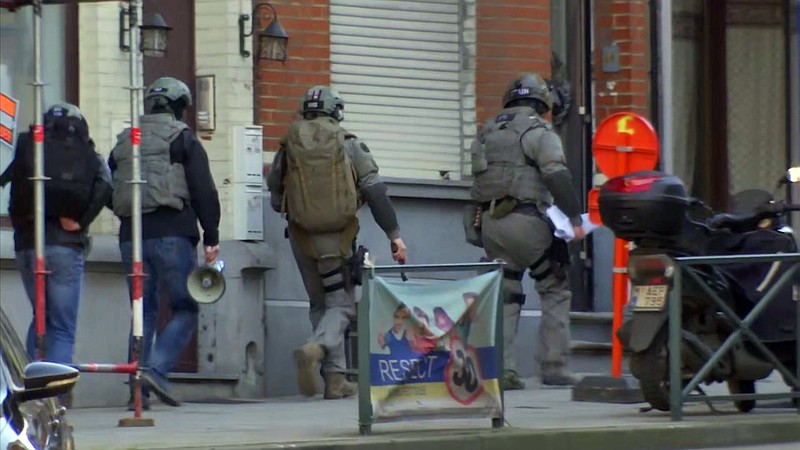 
              Belgium security personnel enter a building in Brussels in this image taken from TV Thursday Feb. 22, 2018. Belgian police have sealed off part of a Brussels suburb amid media reports that an armed man could be at large. (AP Photo)
            
