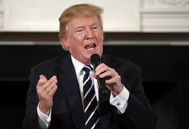 President Donald Trump speaks as he hosts a listening session with high school students, teachers and parents in the State Dining Room of the White House in Washington, Wednesday, Feb. 21, 2018. (AP Photo/Carolyn Kaster)