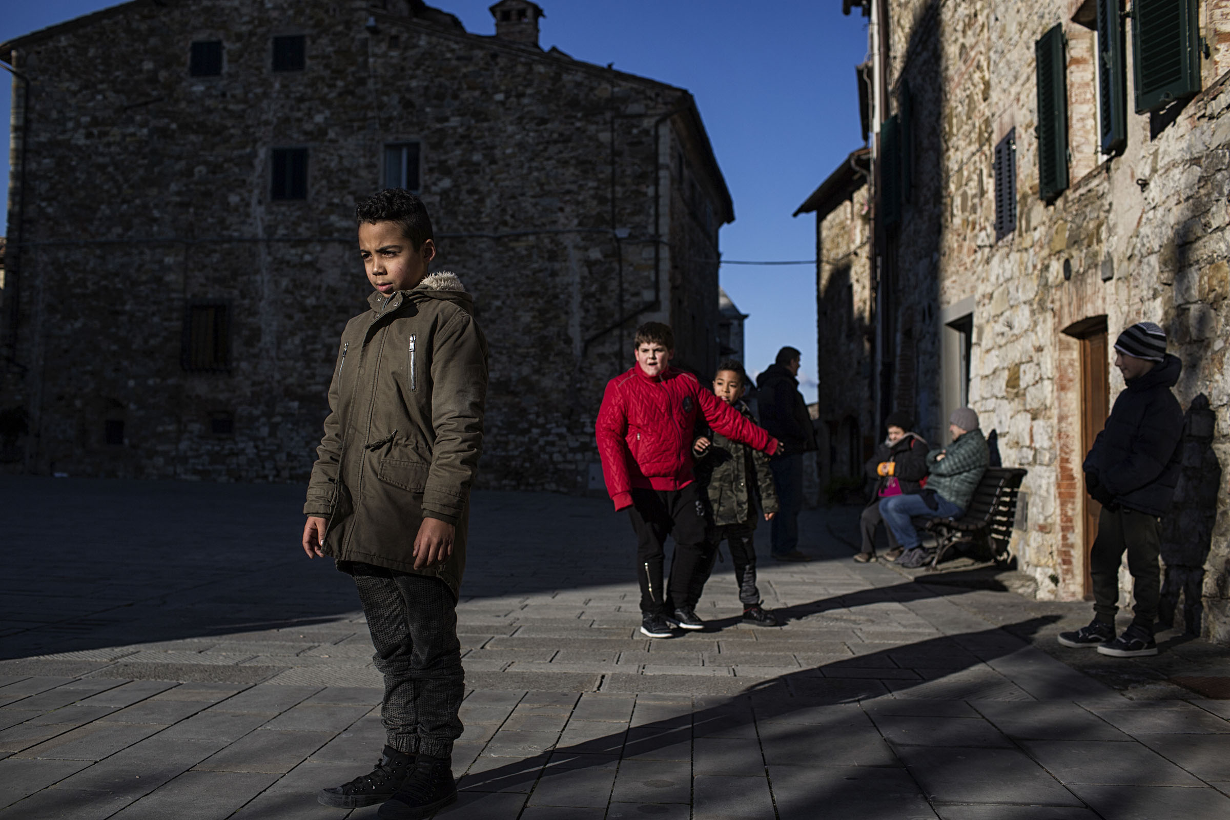 Bilal El Hartika, left, 9, was born in Tuscany to Moroccan parents, plays soccer with friends after school in Castellina in Chianti, Italy, Dec. 19, 2017. Even in tradition-steeped Tuscany, immigration is changing the face of Italy; here, migrants now tend the fields, care for the elderly, and fill the schools. "I am Moroccan and Italian, from Castellina,” Bilal said. (Nadia Shira Cohen/The New York Times)