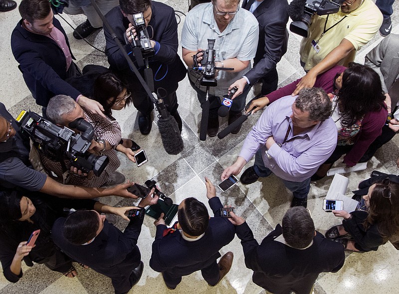 The press gather around Democrat Rep. Carlos Guillermo Smith for comments after the Republican leadership laid out their school safety proposal during a new conference at the Florida Capitol in Tallahassee, Fla., Friday, Feb 23, 2018. (AP Photo/Mark Wallheiser)

