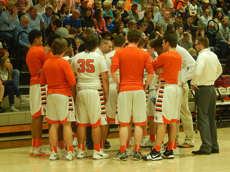 LaFayette boys' basketball coach Hank Peppers, center, instructs his team during a late timeout during the Ramblers' 53-51 victory over Jefferson in a Class 4A second round state-tournament game.