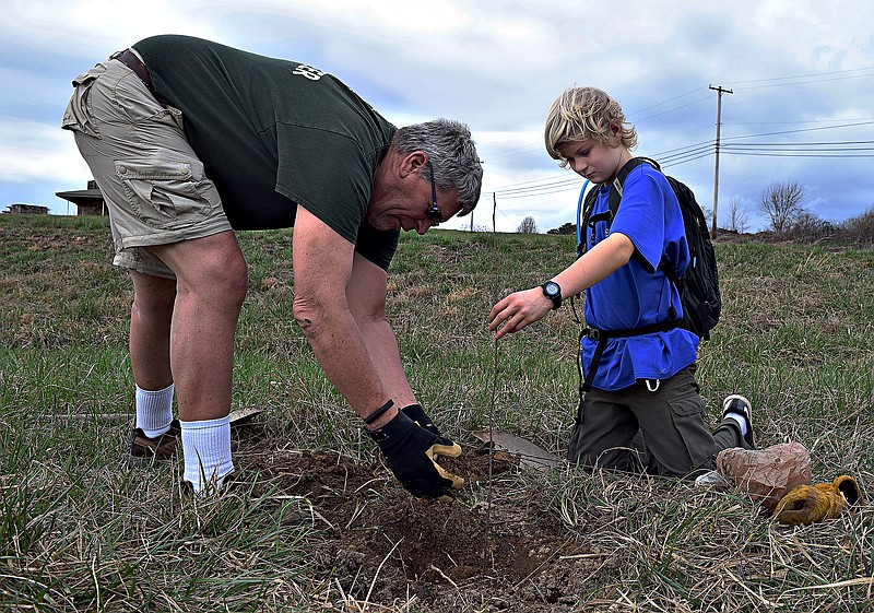 Mark Pace/Chattanooga Times Free Press - Larry Jablonski, left, and Jacob Oster plant a yellow poplar tree Feb. 24 at Lula Lake Land Trust. Residents planted approximately 250,000 trees Saturday statewide.