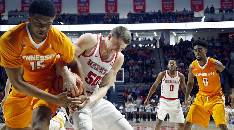 Tennessee forward Derrick Walker, left, and Ole Miss forward Justas Furmanavicius fight for control of the ball during Saturday's game in Oxford, Miss. Walker played 22 minutes and finished with seven rebounds and five points.