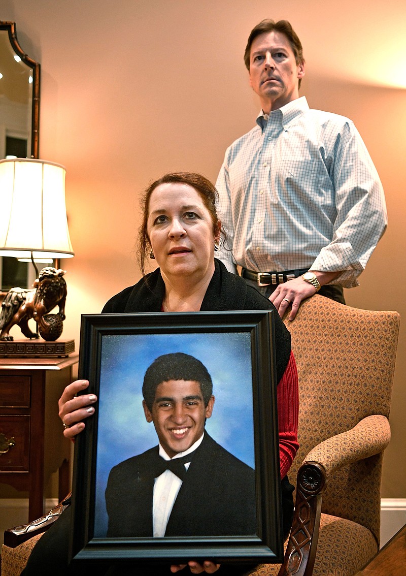Liz Beatty and her husband Yarnell pose with a photo of their son Alex Tuesday Feb. 13, 2018, in Brentwood, Tenn.. The Beatty's son, Alex, died from an accidental drug overdose in 2016. Since he died, they've been inspired to create a greater dialogue in Williamson County about substance abuse and addiction in young people.  (Larry McCormack/The Tennessean via AP)