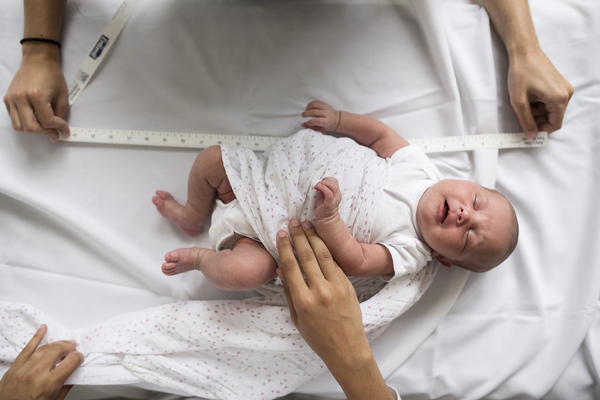 FILE — A 2-week-old is measured at the University of North Carolina's Biomedical Research Imaging Center in Chapel Hill, June 30, 2017. Researchers sought to find out what happens when babies are allowed to feed themselves, in the hopes that they would naturally eat the right amount and that fewer would be overweight, but the results didn’t support that. (Karsten Moran/The New York Times)