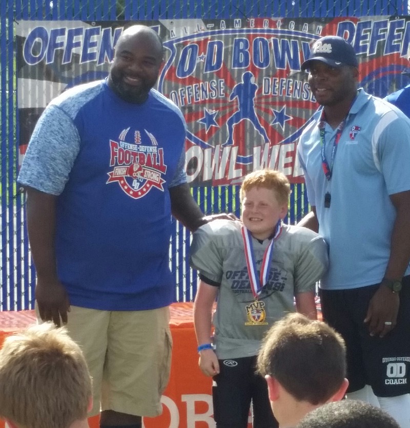 Gunner Moore, 9, meets former NFL players Albert Haynesworth, left, and Bryan Knight at the 12th annual Offense-Defense Bowl Week, which the Soddy-Daisy youth was invited to participate in after being named an O-D All-American. (Contributed photo)