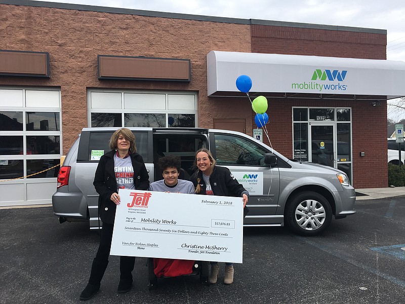 Misty Swafford, left, and son Nolan Staples receive the remaining $17,000 needed for a wheelchair-accessible van from Jett Foundation representative Dannielle Edwards.