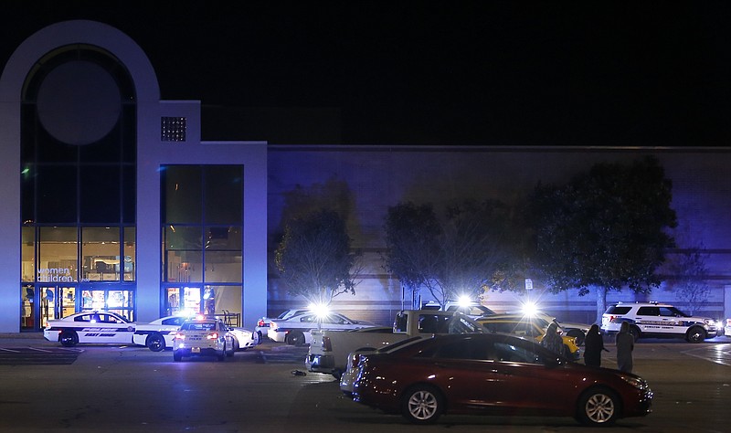 The exterior of the Hamilton Place mall is illuminated blue by police lights from a row of vehicles on Saturday, Feb. 24, 2018 in Chattanooga, Tenn.