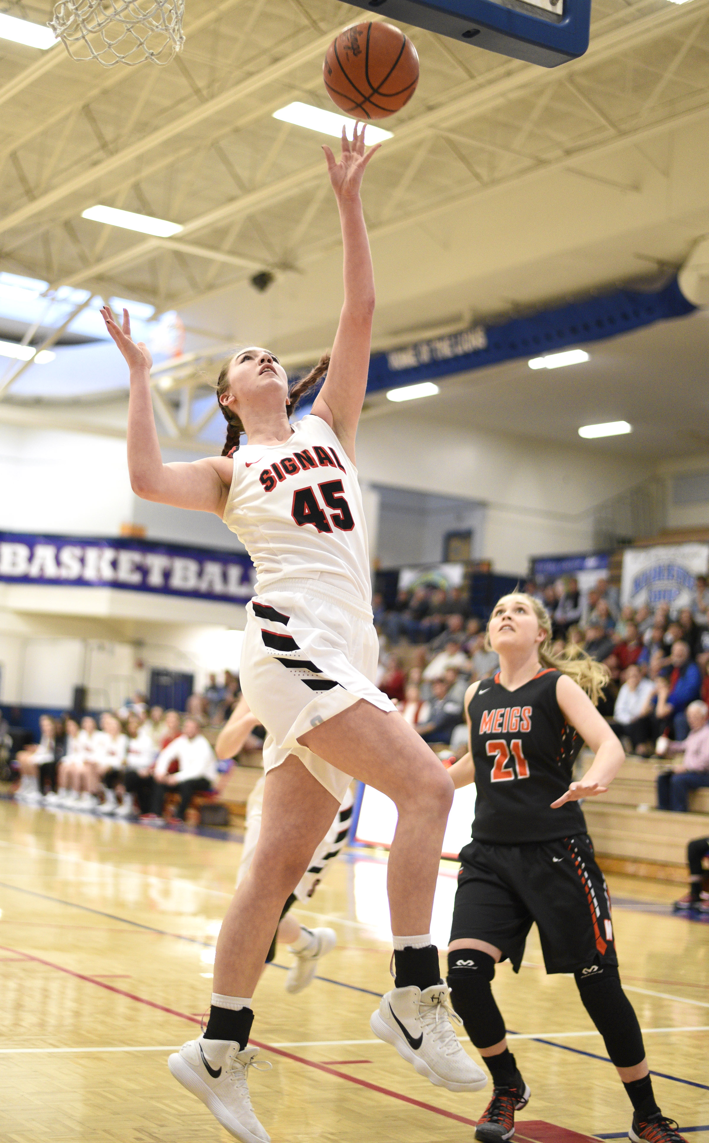 Signal Mountain's Olivia Koontz (45) goes in for a layup past Meigs's Kaylie Moore (21). The Meigs County Tigers played the Signal Mountain Eagles in the semi-final game of the girls's Region 3-AA TSSAA Tournament held at Red Bank High School on February 26, 2018.