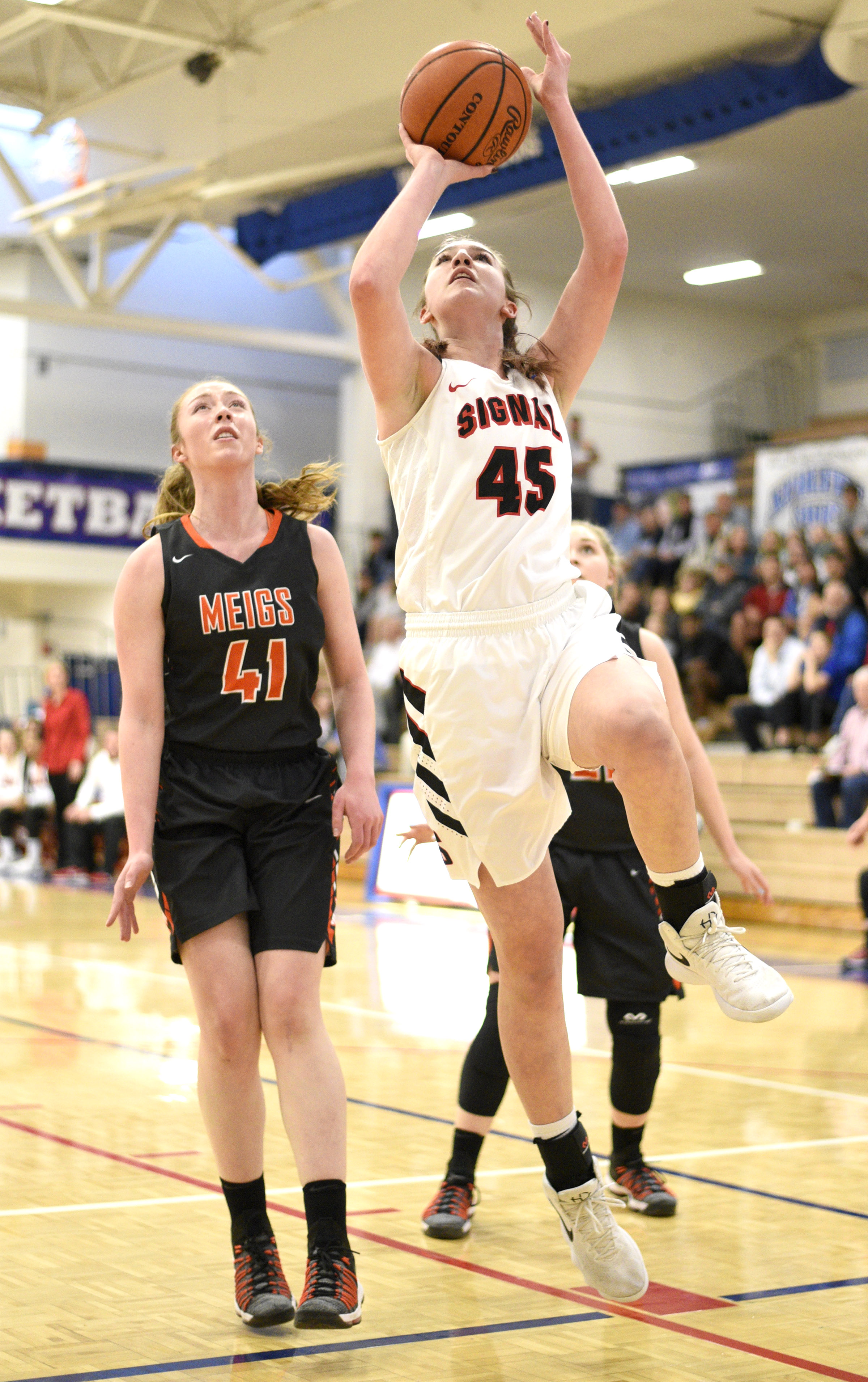 Signal Mountain's Olivia Koontz (45) drives to the basket past Meigs's Jada Meadows (41). The Meigs County Tigers played the Signal Mountain Eagles in the semi-final game of the girls's Region 3-AA TSSAA Tournament held at Red Bank High School on February 26, 2018.