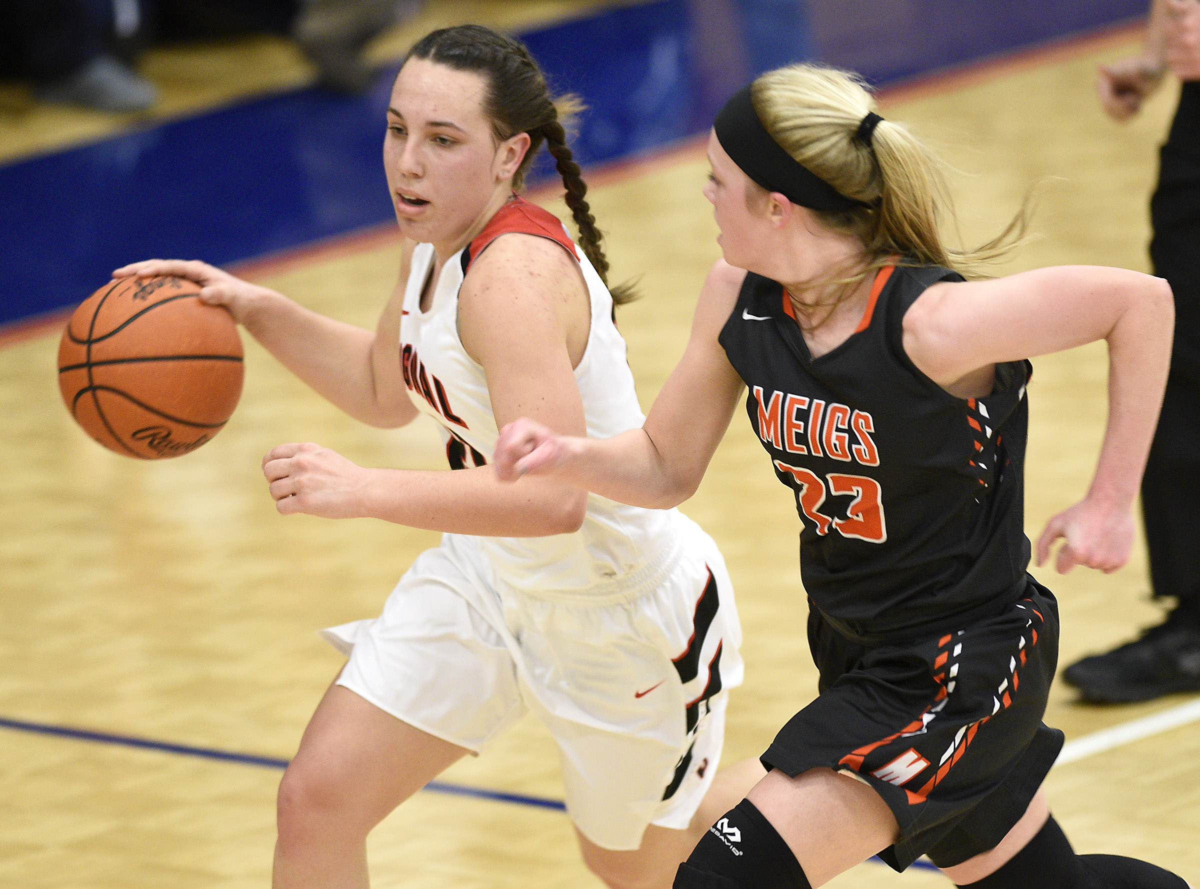 Signal's Jolie McGann (21) races up court followed step-by-step by Meigs's Kassidy Kenny (23). The Meigs County Tigers played the Signal Mountain Eagles in the semi-final game of the girls's Region 3-AA TSSAA Tournament held at Red Bank High School on February 26, 2018.
