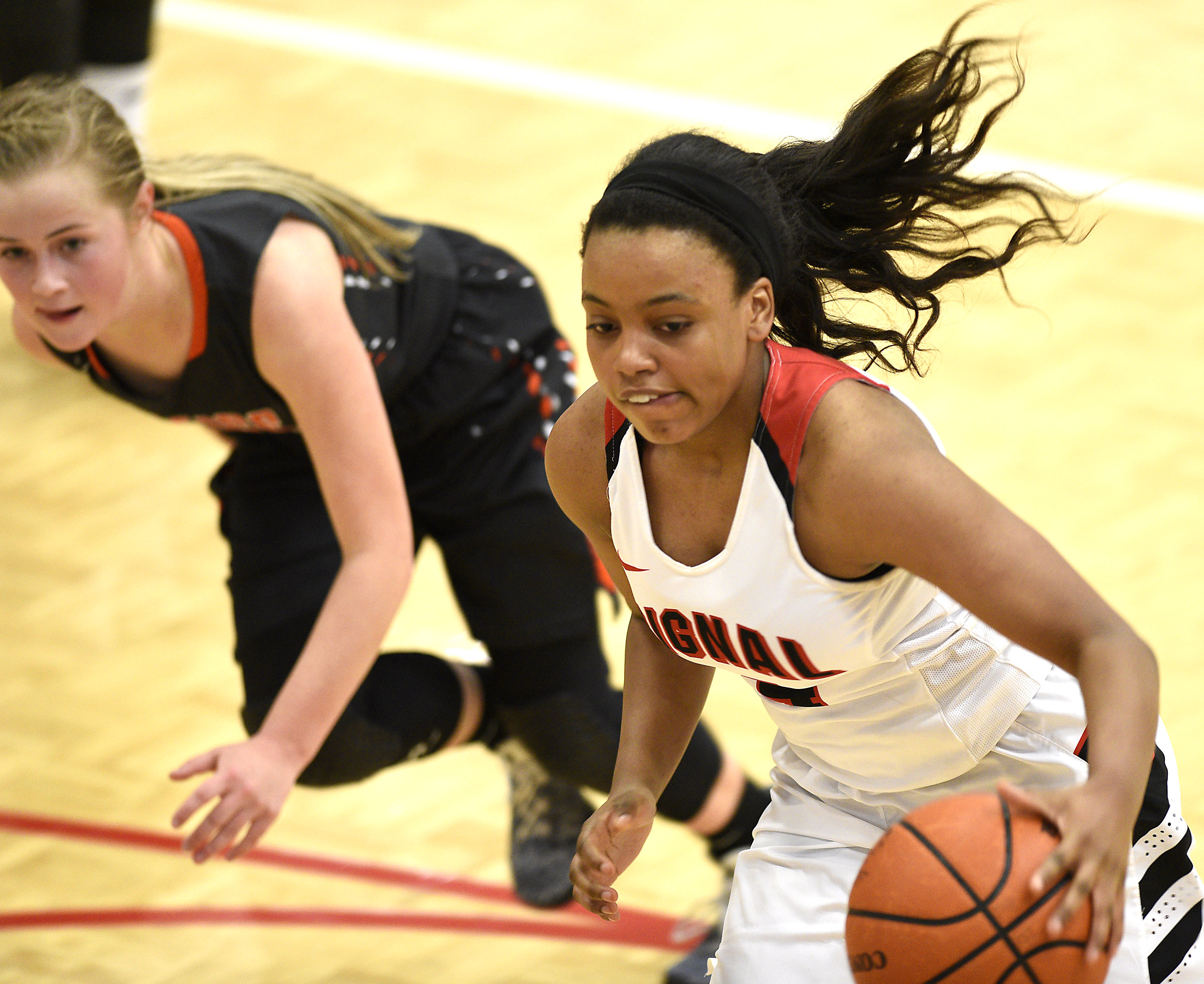 Signal's Kendall Davis (4) drives past Meigs's Kacelyn Stone (4). The Meigs County Tigers played the Signal Mountain Eagles in the semi-final game of the girls's Region 3-AA TSSAA Tournament held at Red Bank High School on February 26, 2018.