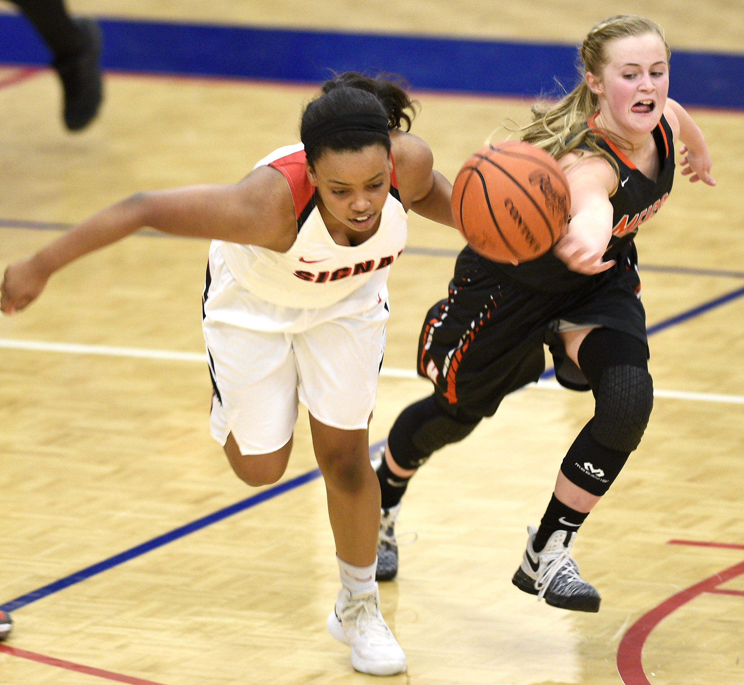 Meigs's Jacelyn Stone (4) knocks the ball from Signal's Kendall Davis (4). Stone would gather in the ball for a steal. The Meigs County Tigers played the Signal Mountain Eagles in the semi-final game of the girls's Region 3-AA TSSAA Tournament held at Red Bank High School on February 26, 2018.