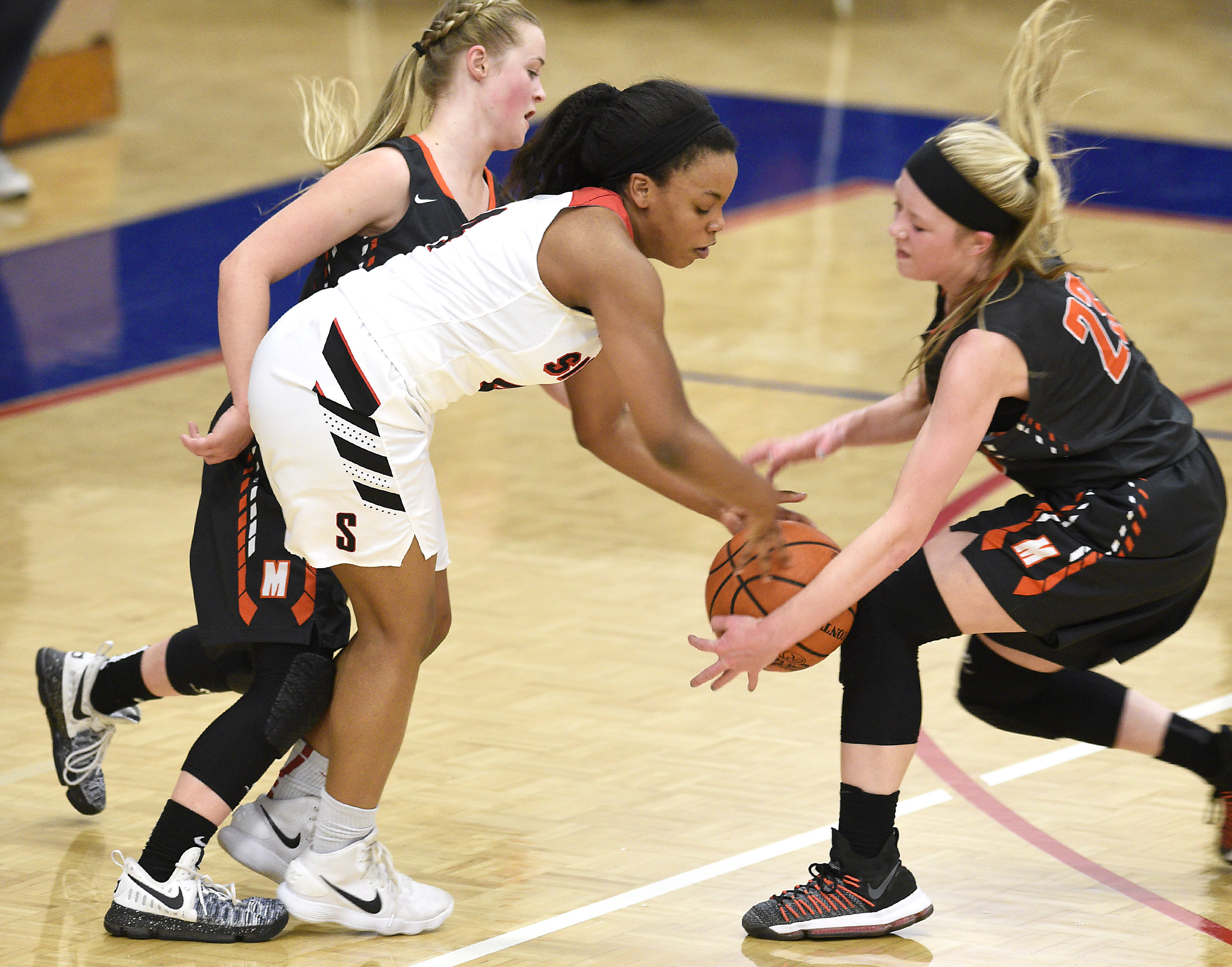 Meigs's Kassidy Kenny (23) steals the ball from Signal's Kendall Davis (4). Also on defense for Meigs is Jacelyn Stone (4). The Meigs County Tigers played the Signal Mountain Eagles in the semi-final game of the girls's Region 3-AA TSSAA Tournament held at Red Bank High School on February 26, 2018.