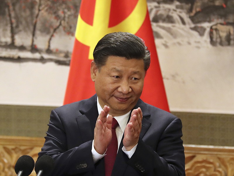 In this Oct 25, 2017, file photo, Chinese President Xi Jinping claps while addressing the media as he introduces new members of the Politburo Standing Committee at Beijing's Great Hall of the People. On a proposal made public Sunday, Feb. 25, 2018, China's ruling Communist Party proposes removing a limit of two consecutive terms for the president and vice president. (AP Photo/Ng Han Guan, File)