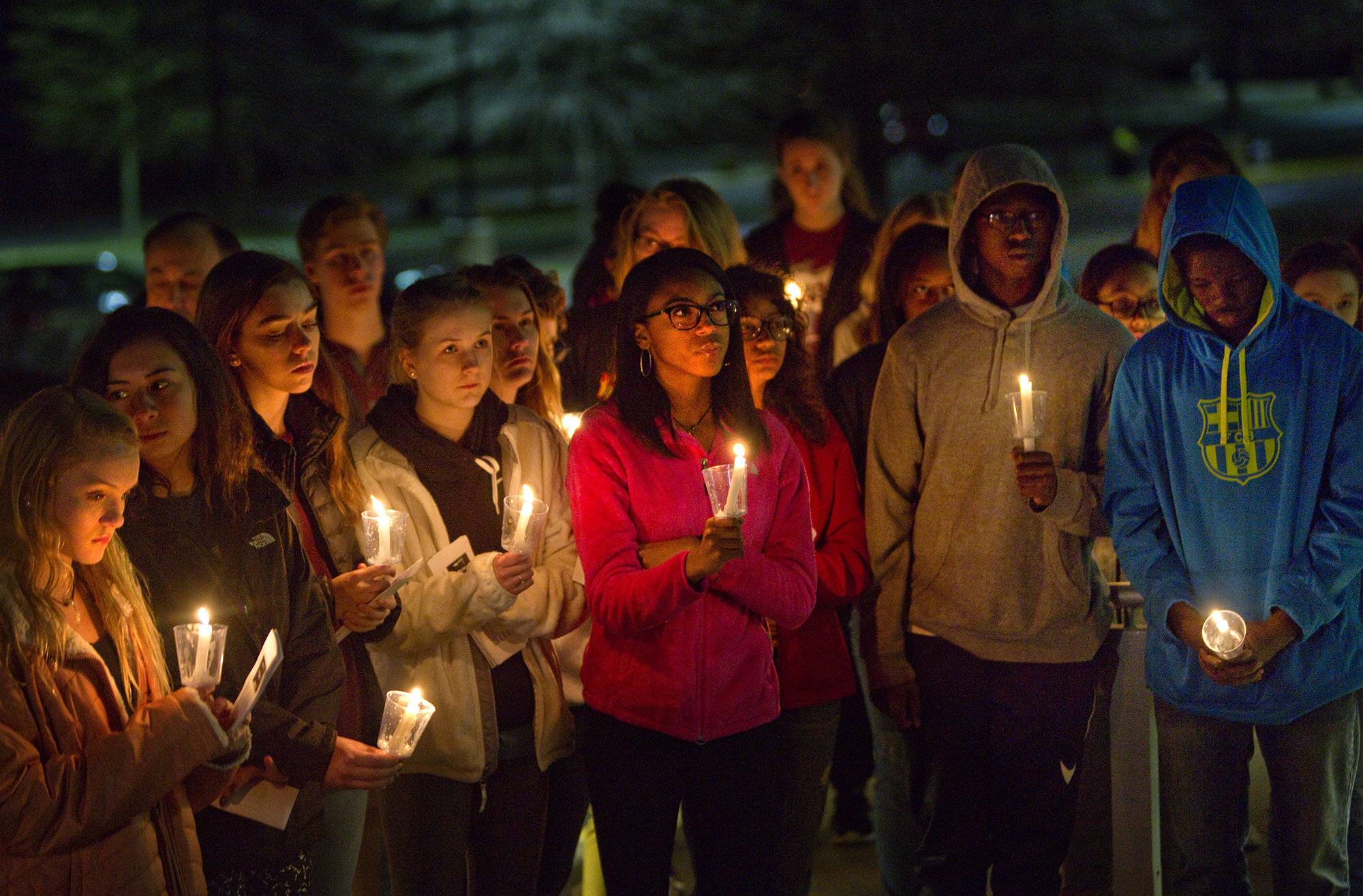 Patrick Henry High School students hold candles in memory of those killed in the recent Florida school shooting, during a candle vigil at the school in Roanoke, Va., Monday, Feb. 26, 2018. (Heather Rousseau/The Roanoke Times via AP)