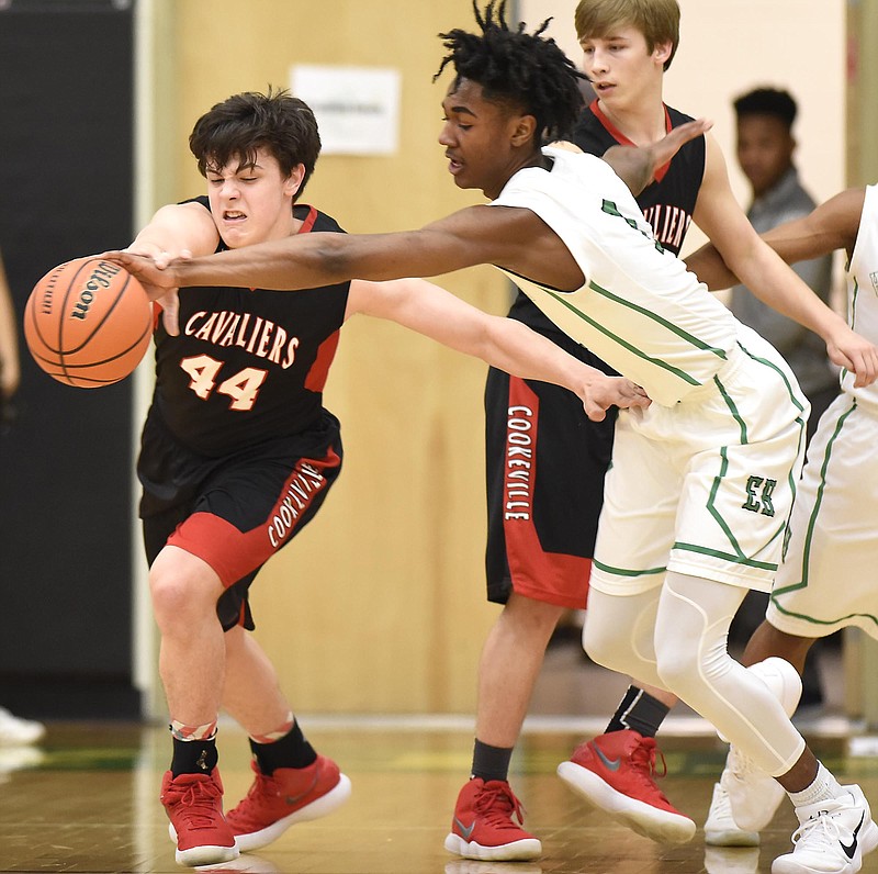 East Hamilton's Drew Williams (1) knocks the ball away from Cookeville's Alex Garrett (44).  The Cookeville Cavaliers faced the East Hamilton Hurricanes in region TSSAA basketball on February 23, 2018