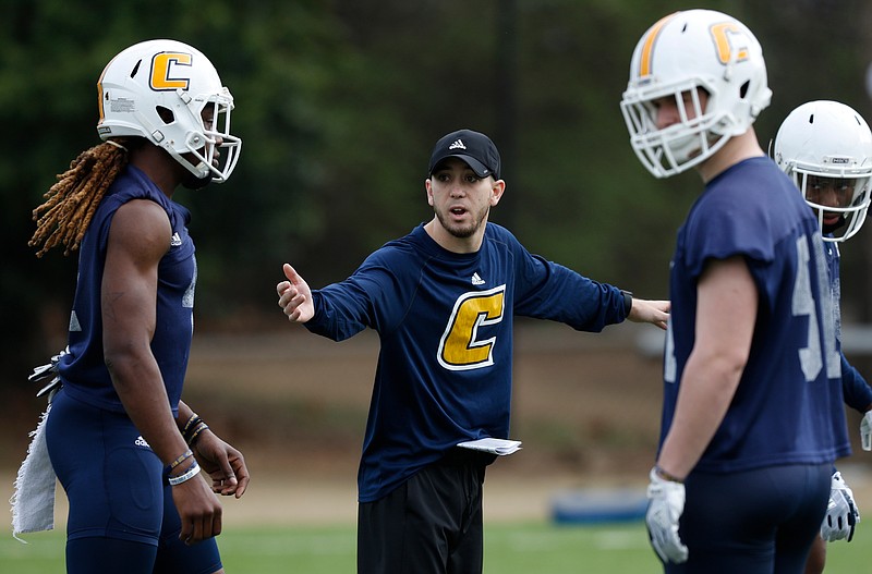 Corners coach Jeremiah Wilson directs players during the UTC football team's first spring practice at Scrappy Moore Field on Saturday, Feb. 24, 2018, in Chattanooga, Tenn. 