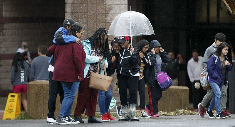 Staff photo by C.B. Schmelter / 
People hug one another outside of the Dalton Convention Center on Wednesday, Feb. 28, 2018 in Dalton, Ga. Students from Dalton High School were evacuated to the Dalton Convention Center after social studies teacher Randal Davidson allegedly barricaded himself in a classroom and fired a handgun.