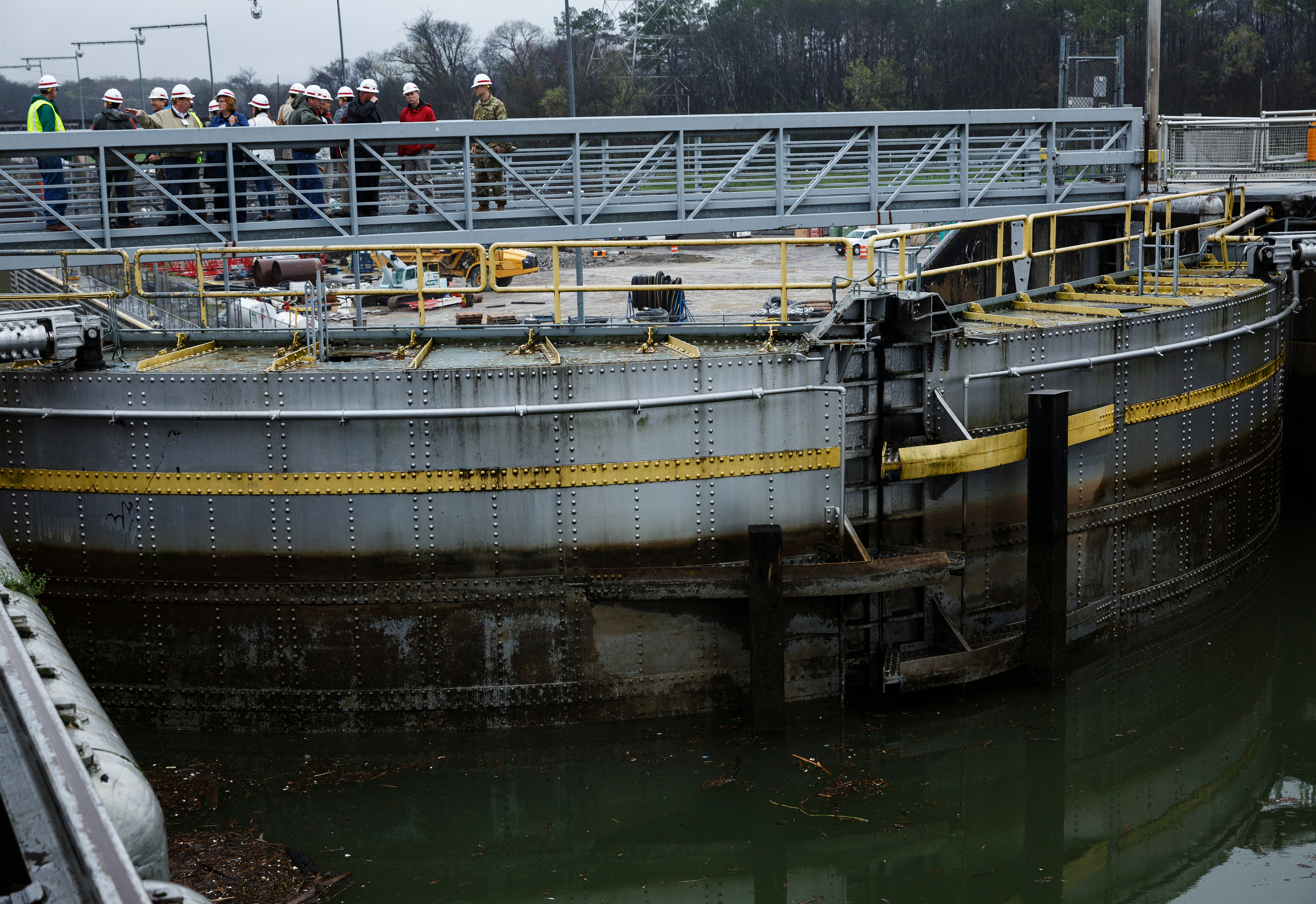 Visitors with the Inland Waterways Users Council stand atop the functioning Chickamauga Dam Lock door on Wednesday, Feb. 28, 2018, in Chattanooga, Tenn. The Inland Waterways Users Council took a tour of the lock.