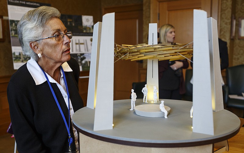 Liz Henley examines RE:site Studio's design concept for a "Fallen Five" memorial on Nov. 15, 2017. The Hamilton County Commission and Chattanooga City Council will vote next week whether to put in $250,000 each for the memorial honoring the five servicemen killed in the July 16, 2015, attacks on military facilities here. Another $250,000 is to be raised from the private sector.