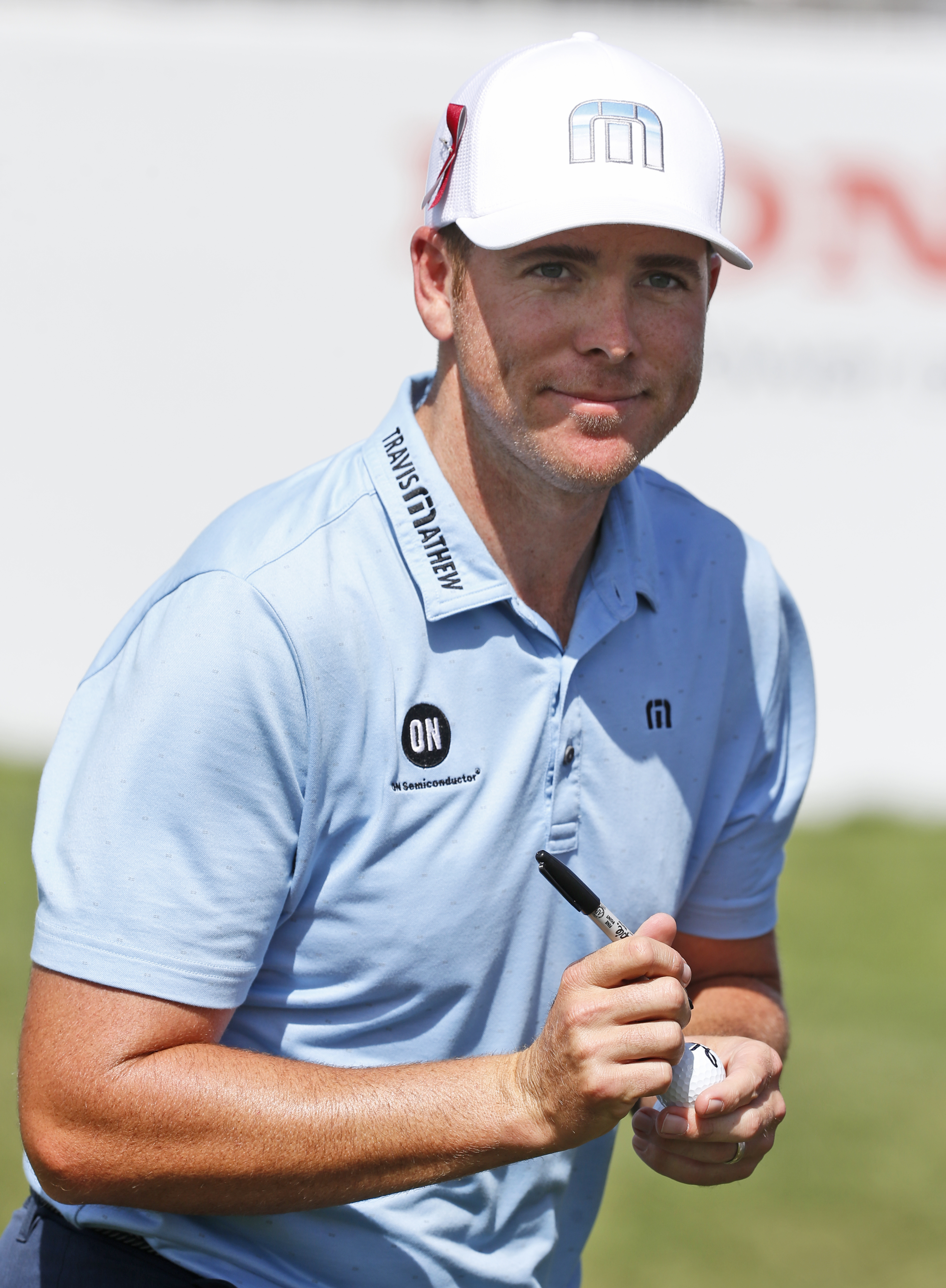 Luke List autographs a golf ball after finishing the second round of the Honda Classic golf tournament, Friday, Feb. 23, 2018 in Palm Beach Gardens, Fla. (AP Photo/Wilfredo Lee)