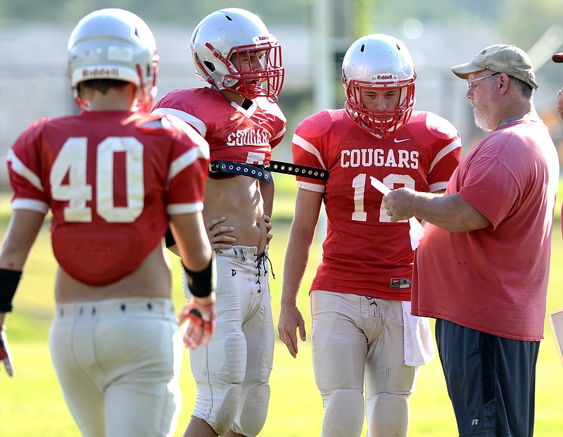 Patrick Daley talks with players during a preseason football practice last August at Copper Basin High School. Daley, a 1985 graduate of the school, was the Cougars' head coach the past 12 years. He has resigned to spend more time with his family.