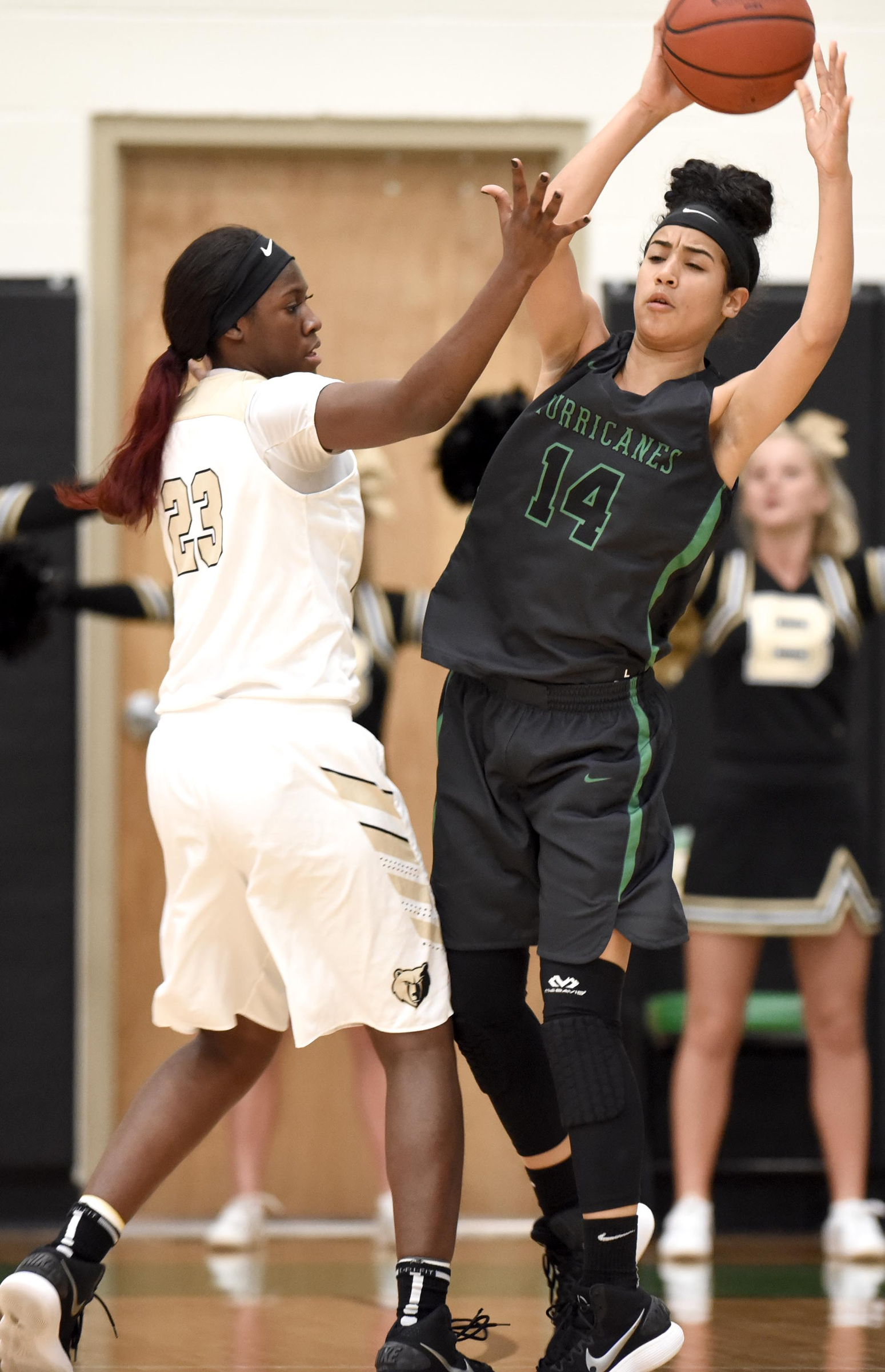 East Hamilton's Madison Hayes (14) passes while Bradley's Rhyne Howard (23) defends.  The East Hamilton Lady Hurricanes met the Bradley Central Bears for the Region 3AAA TSSAA girls'  basketball championship on February 28, 2018
