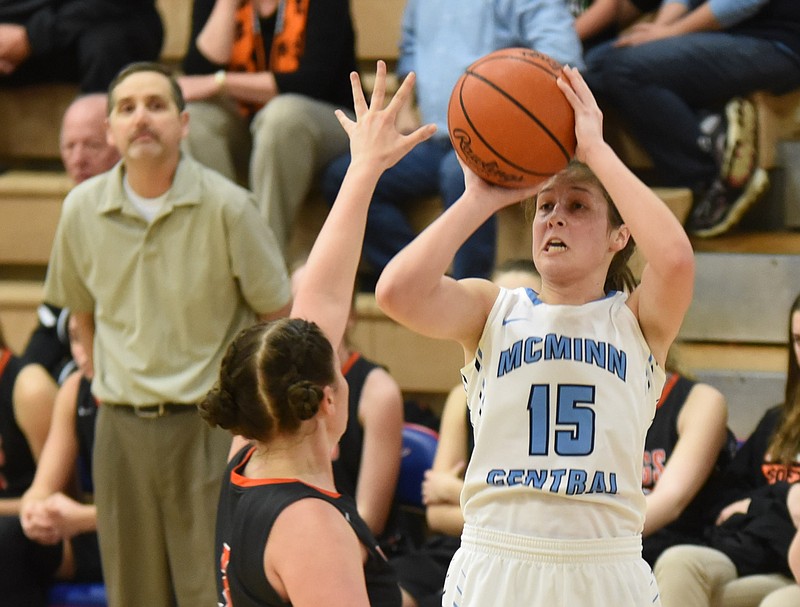 McMinn Central's Melia Baker (15) shoots over to top of Meigs County's Macie Boggess for two of her points in the Region 3-AA girls' championship game Wednesday at Red Bank.