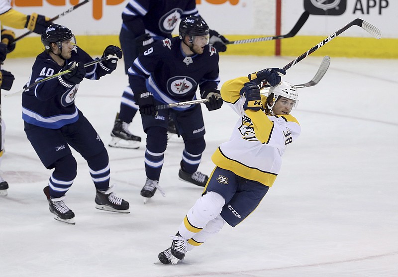 Nashville Predators' Ryan Hartman (38) spins after being checked by Winnipeg Jets' Joel Armia (40) during the first period of an NHL hockey game Tuesday, Feb. 27, 2018, in Winnipeg, Manitoba. (Trevor Hagan/The Canadian Press via AP)